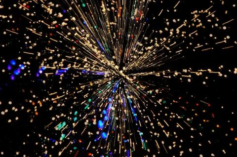 Exploding blasts of sparks burst out into the darkness of space Stock Photos