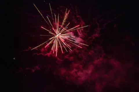 Exploding bright red firework in dark night Stock Photos
