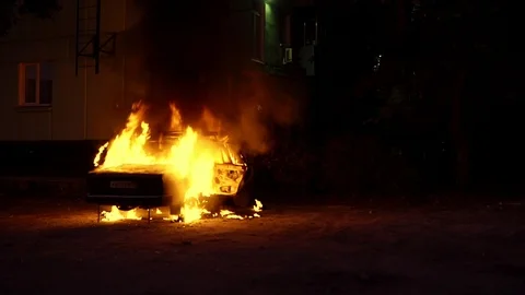Exploding burning car on fire in front of building Stock Footage 115269384