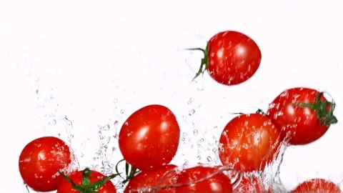 Exploding cherry tomatoes with water on a black background. Stock Footage 132496051