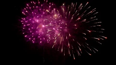 Exploding colorful fireworks display illuminating night sky background. Vídeos de archivo 344000817