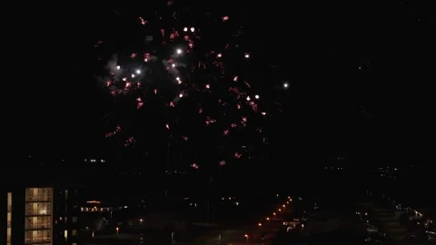 Exploding firework rockets at night sky of american town. Aerial wide shot. New Video stock 328281600