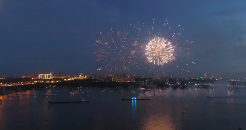 Exploding fireworks over the river in the night sky Stock Footage 92080253