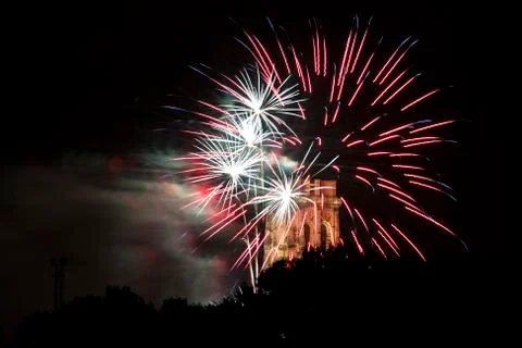 Exploding fireworks rockets with red and white clouds. Stock Photos
