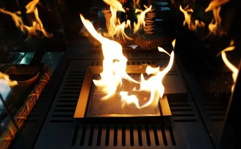 Exploding flames black background. Fireplace with just like fire Burning in cafe Stock Photos