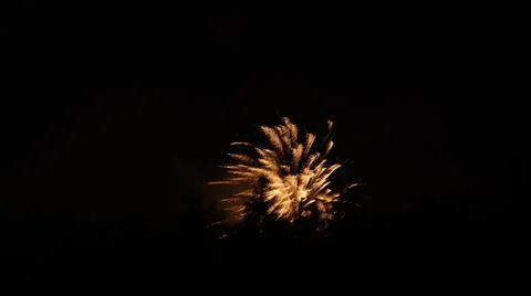 Exploding gold fireworks on a black background 写真素材