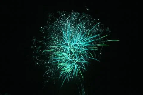 Exploding green fireworks on a black background Stockfoto's