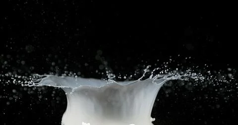 Exploding Milk against Black Background Stockfoto's