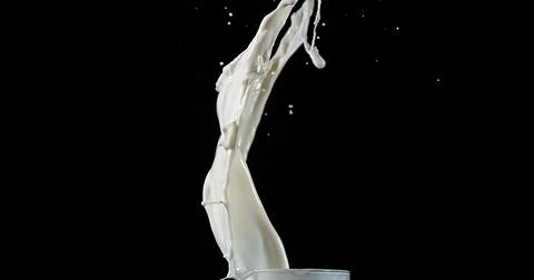 Exploding Milk against Black Background Foto stock