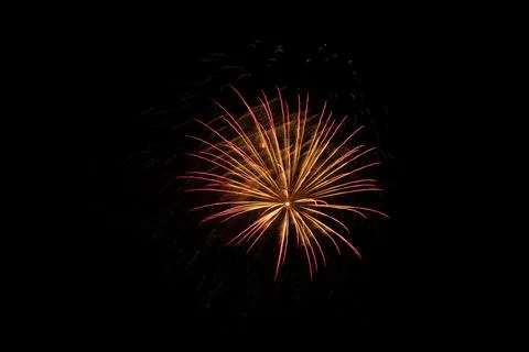 Exploding orange fireworks on a black background Foto stock