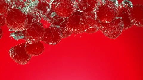 Exploding raspberries with water on a black background. Stock Footage 256820569