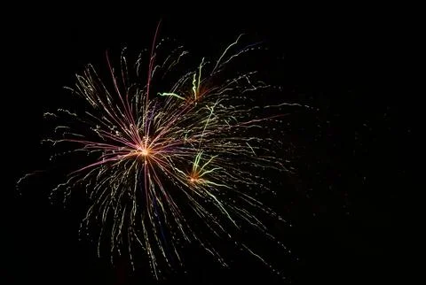 Exploding red firework against a black sky Fotos de archivo