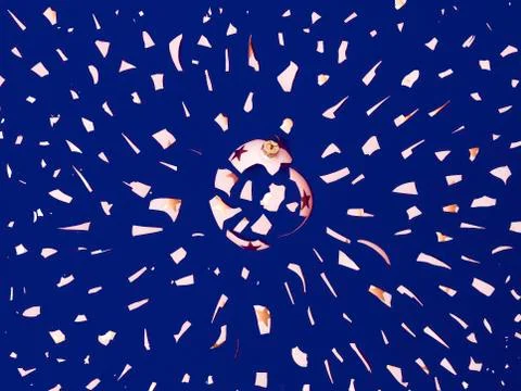 Exploding white bauble on blue background Stock Photos