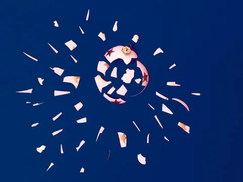 Exploding white bauble on blue background Stock Photos