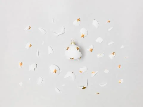 Exploding white bauble on grey background Stock Photos
