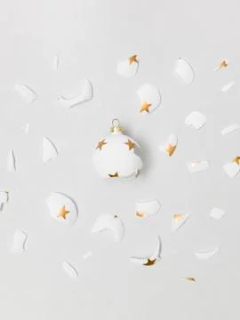 Exploding white bauble on grey background Stock Photos