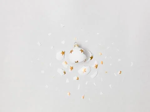Exploding white bauble on grey background Stock Photos