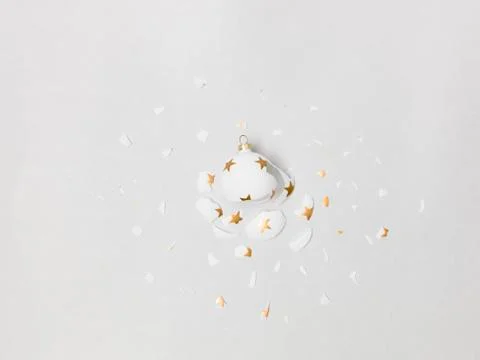Exploding white bauble on grey background Foto stock