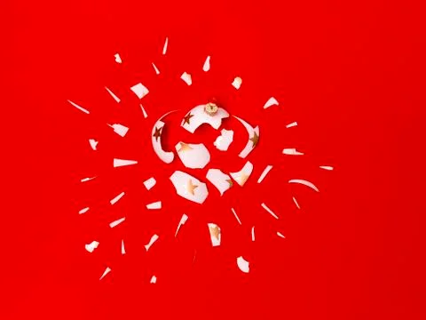 Exploding white bauble on red background 写真素材