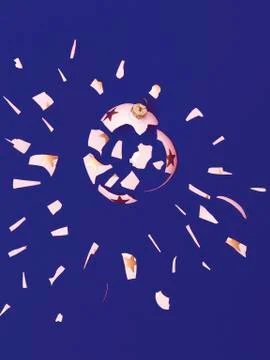 Exploding white bauble on violet background Stock Photos