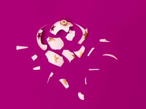 Exploding white bauble on violet background Stock Photos