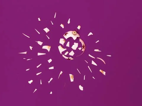 Exploding white bauble on violet background Stock Photos