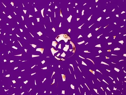 Exploding white bauble on violet background Stock Photos