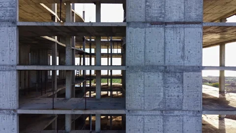 Exploration of abandoned concrete structure in a serene landscape during golden Stock Footage 332096803