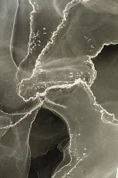 Exploration of fluid shapes and patterns created using alcohol ink on a textured Illustrazione stock