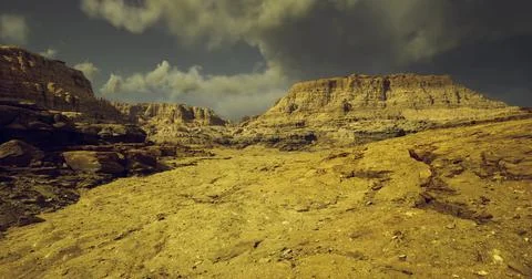 Exploration of rugged terrain under a dramatic sky in a desert landscape Stockillustratie