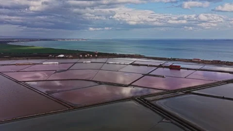 Exploration of salt mining operations along coastal area in the daytime Video stock 335141001