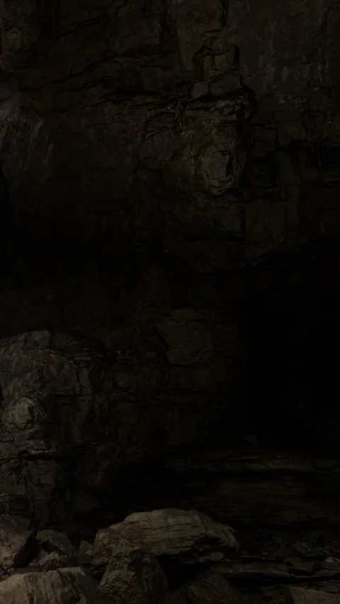 Exploration of an underground cave with rock formations and shadows Stock Footage 331742647