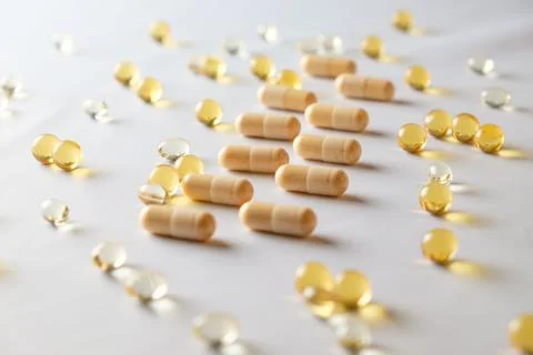 Exploration of various supplements on a clean, white surface in natural light Stock Photos
