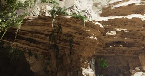Exploration of a vast cave with rock formations and lush greenery Stock Footage 314938323