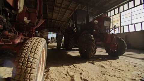 Explore abandoned warehouse with old tractors in deserted military base Stock Footage 319981158
