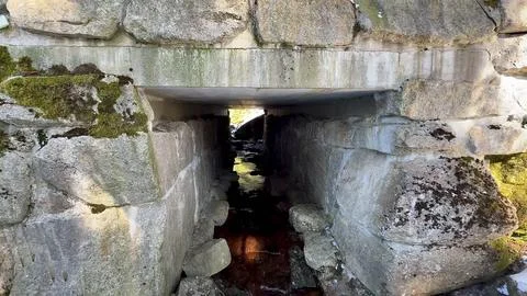 Explore the Ancient Stone Structure with a flowing water creek in a beautif.. Stock Photos