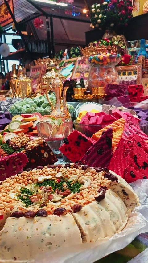 Explore an array of traditional sweets and snacks showcased at a bustling market 動画素材 316310323