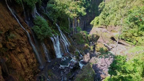 Explore the Awe-Inspiring Tumpak Sewu Waterfall in Java, Indonesia Stock-Footage 317619297
