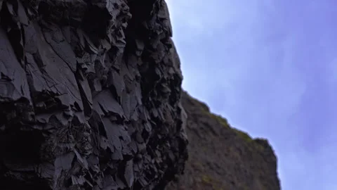Explore basalt rocks and sky at Reynisfjara Beach near Vik in Iceland Video stock 329442733