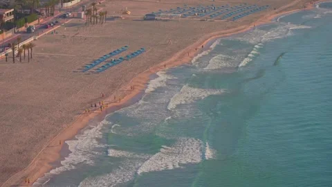 Explore the beaches of Benidorm with sun, waves, and visitors enjoying their tim Stock Footage 337151985