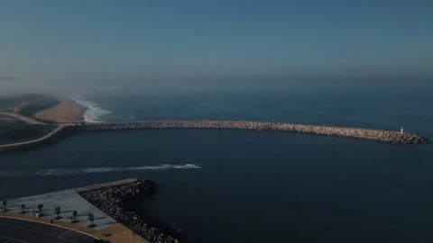 Explore breakwater sea jet ski beach on a sunny day with amazing views Stock Footage 321500360
