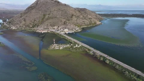 Explore the breathtaking aerial view of Skadar Lake surrounded by mountains and Video stock 287791942