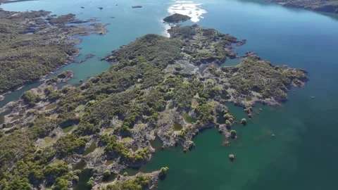 Explore the breathtaking aerial view of Slansko Lake showcasing its lush islands Stock Footage 287794376