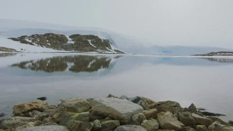 Explore the breathtaking Antarctica mountains as snow clouds gather over Stock Footage 288183352