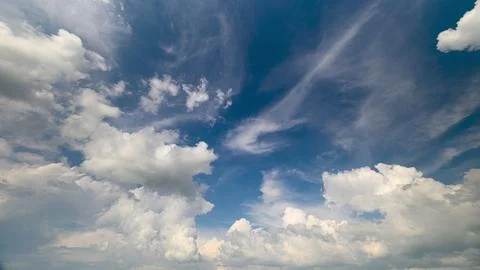 Explore the breathtaking dynamic cloud patterns displayed against a vibrant blue Stock Photos