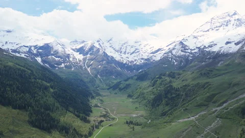 Explore breathtaking mountain landscapes and serene valleys under a vibrant blue Stock-Footage 314078019