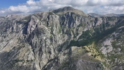 Explore the breathtaking mountain views above Kotor showcasing dramatic cliffs Stock Footage 287756383