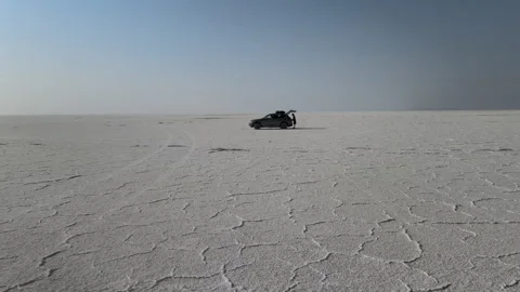 Explore the breathtaking salt flats and mountains under the vast sky Stock Footage 312667757