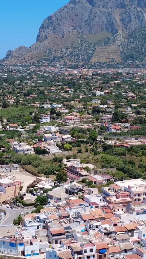 Explore Breathtaking Views of a Coastal Village Surrounded by Mountains in Stock Footage 311111790