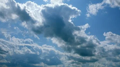 Explore the captivating dynamic cloud patterns that dance across a vibrant clear Stock Photos